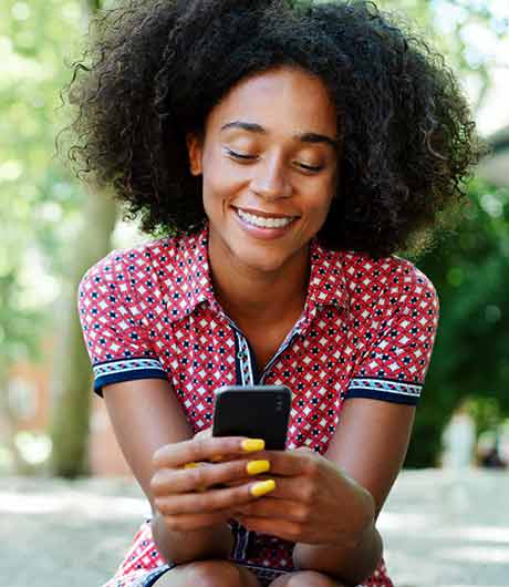 Woman using phone in the park