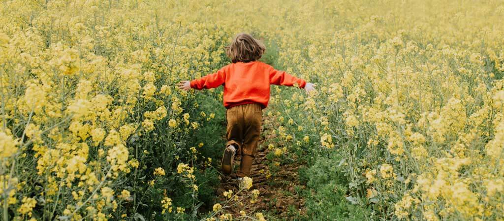 child running through field