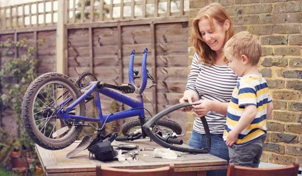 Mother and son fixing bike