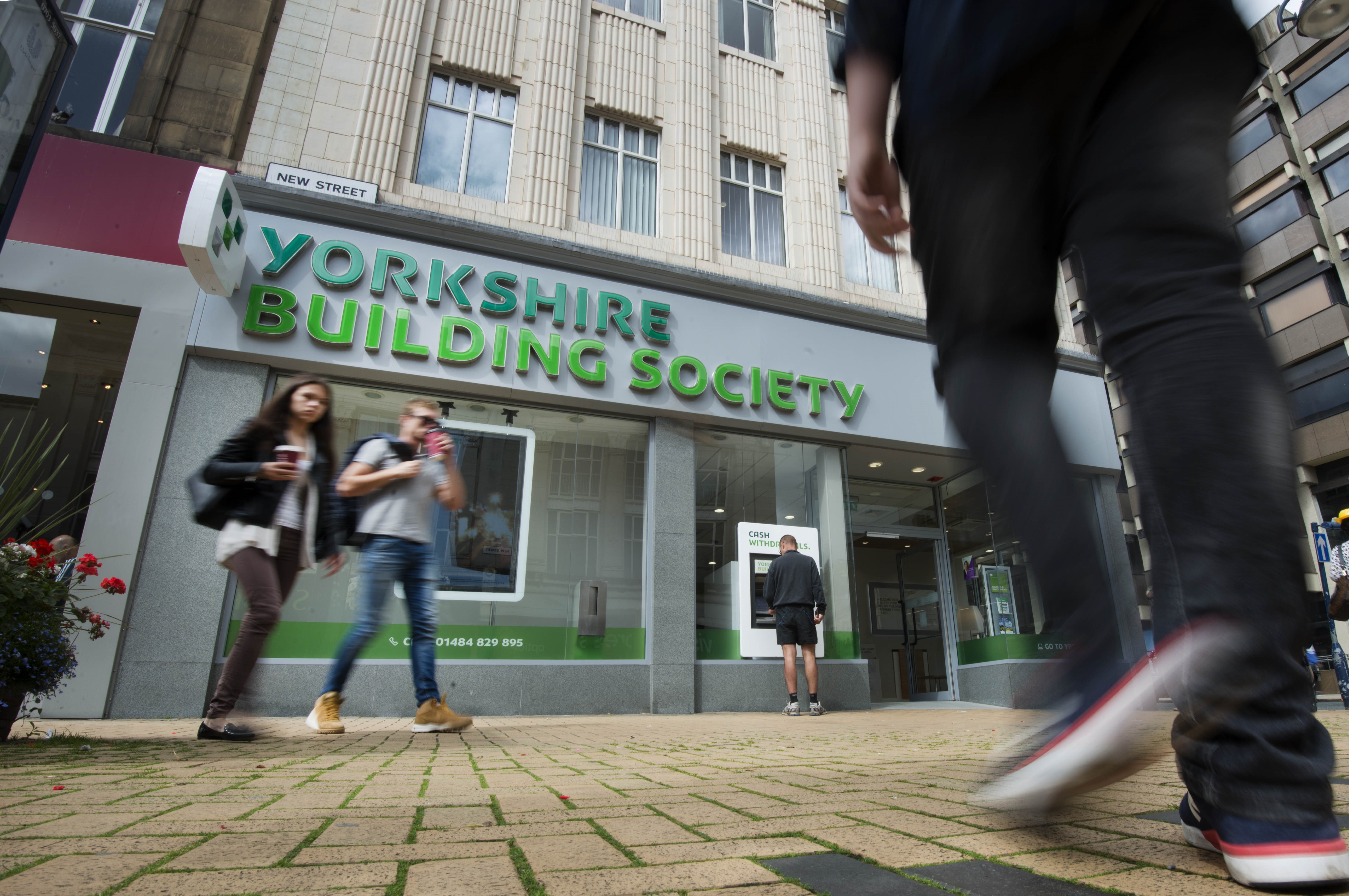 People walk past a branch of Yorkshire Building Society 